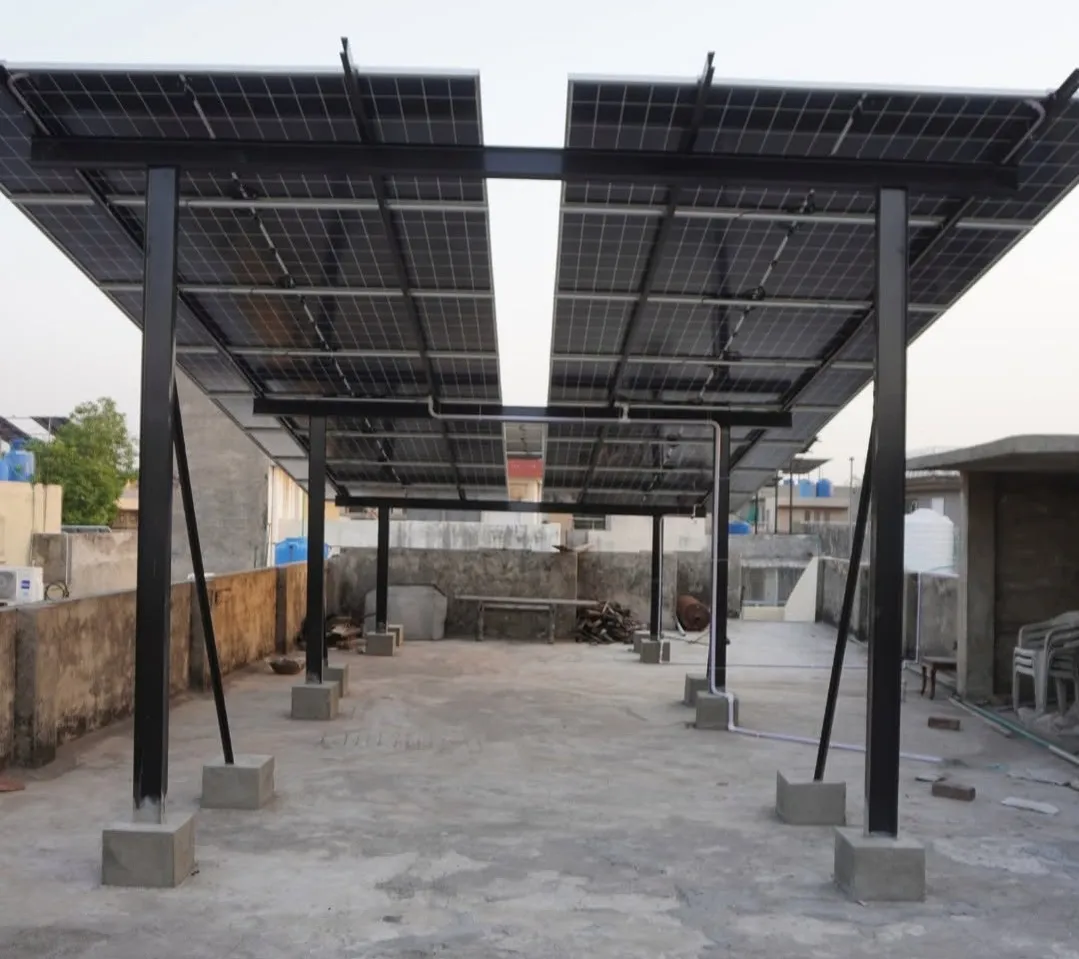 10 kW solar array raised on a tall black steel structure above a Lahore rooftop, on concrete footings