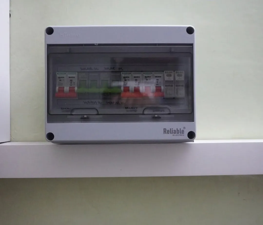 Reliable Electric distribution board with breakers labelled Solar and WAPDA (grid), plus two surge protection devices
